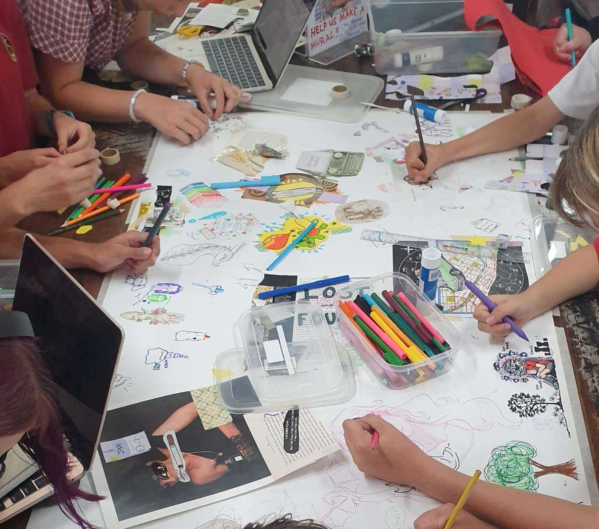 Students working on collaborative collage for Principal's Writing Competition